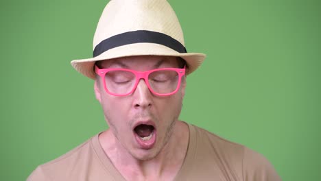 young handsome tourist man looking shocked