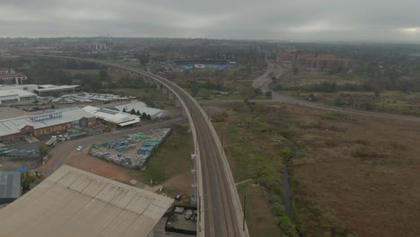 drone aerial following a high speed commuter train line