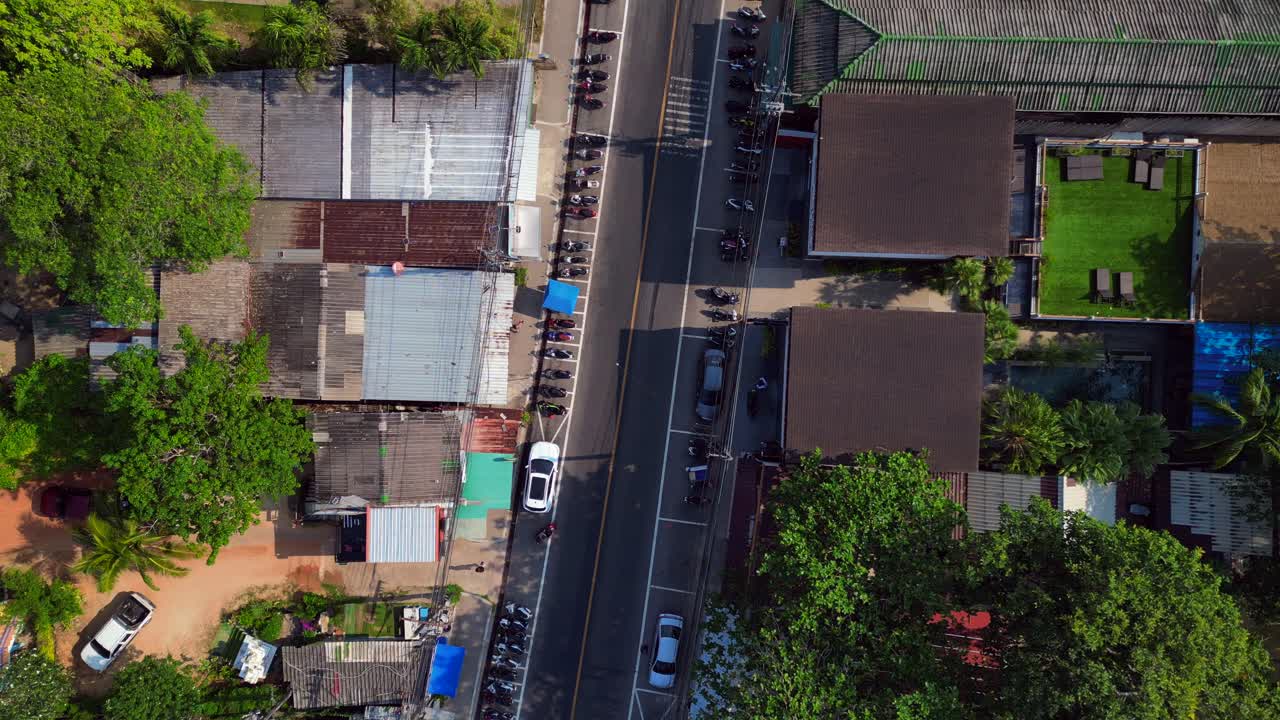A road through a Town on koh chang, thailand, showcasing hotels, Restaurants and bars. Great aerial view flight drone shot footage from above