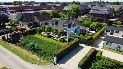 Aerial-of-man-walking-up-to-driveway-to-his-beautiful-house-on-a-nice-summer-day