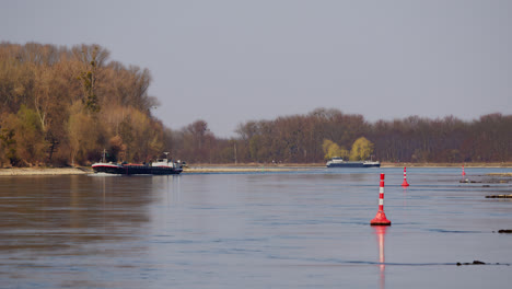 two industrial transport ships sailing with gas or liquids on the rhine near karlsruhe, germany