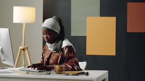 young black woman working in office