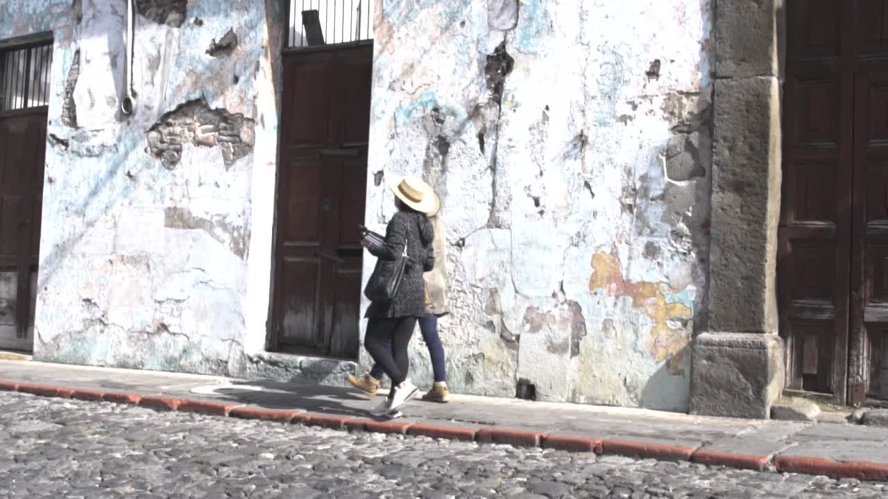 Tourist Women Walking On The Street In An Old Town - Tourism Concept - wide shot