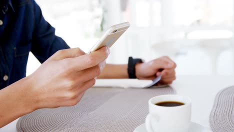 man in lunch bar with smartphone and coffee