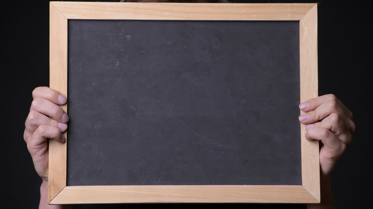 Hand Holding Empty Blackboard