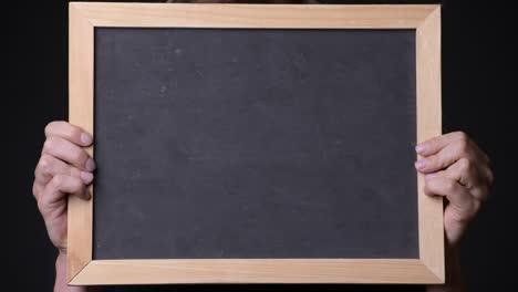 hand holding empty blackboard