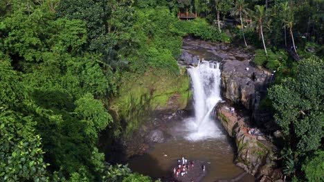 aerial view of tegenungan waterfall with tourists in bali, indonesia