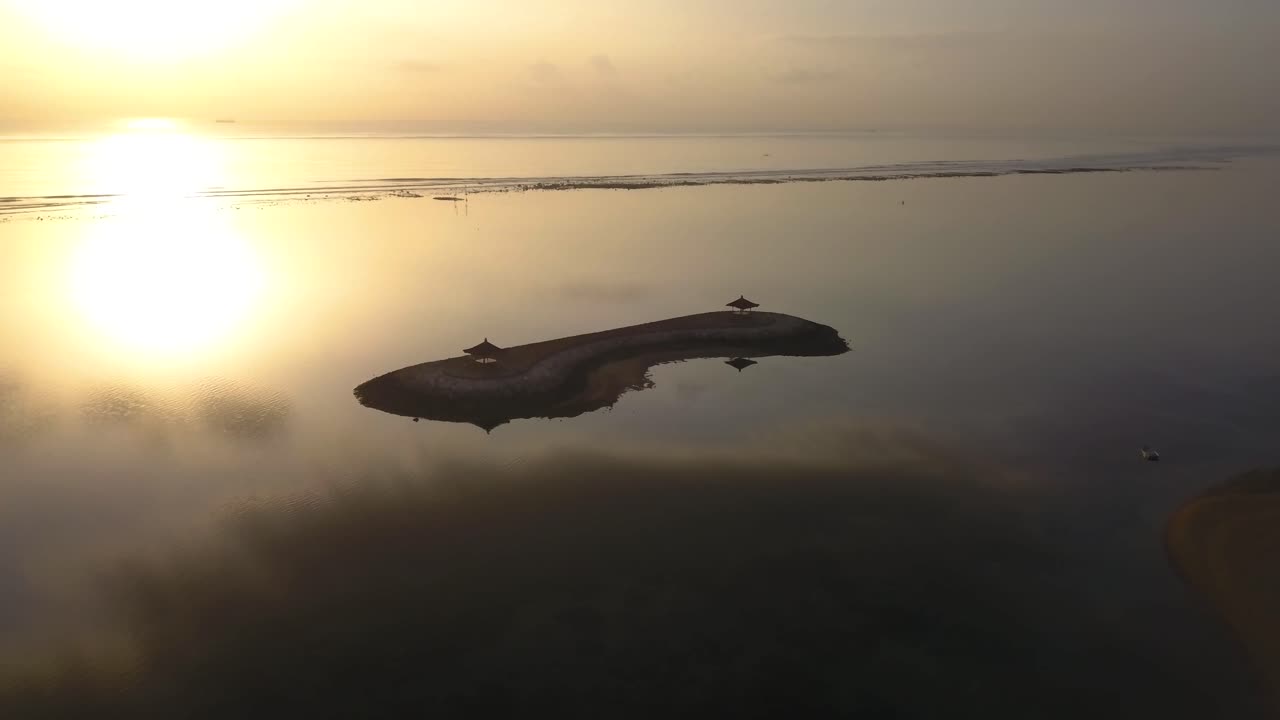 Drone video of Pantai Karang Beach, in Bali, Indonesia at sunrise, left to right