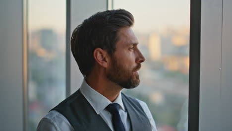 portrait man professional contemplating business deal stand at panoramic window
