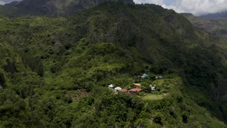 aerial view of a remote village nestled in a lush mountain valley