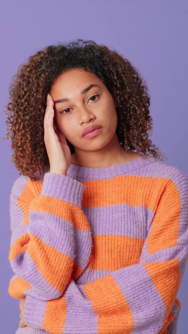 Young Woman Feeling Stressed and Tired Against Purple Background