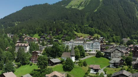 Picturesque-town-with-alpine-houses-and-christian-church,-Switzerland