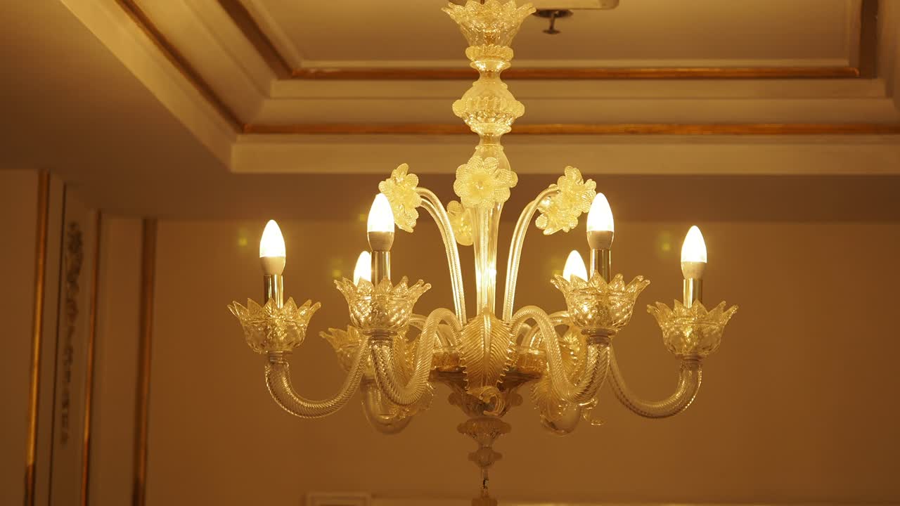 Elegant Ornate Glass Chandelier with Warm Lighting