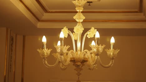 elegant ornate glass chandelier with warm lighting