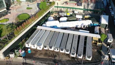 an aerial view over temporary morgue refrigeration trailers containing the bodies of victims of the coronavirus pandemic