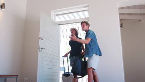 excited couple arriving at summer vacation rental