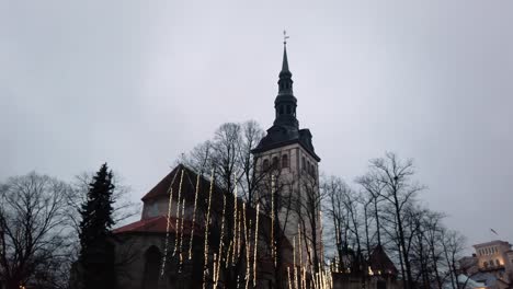 estonia, tallinn, decorated st nicholas church in the old town moving from the top towards the ground level on a cloudy winter day