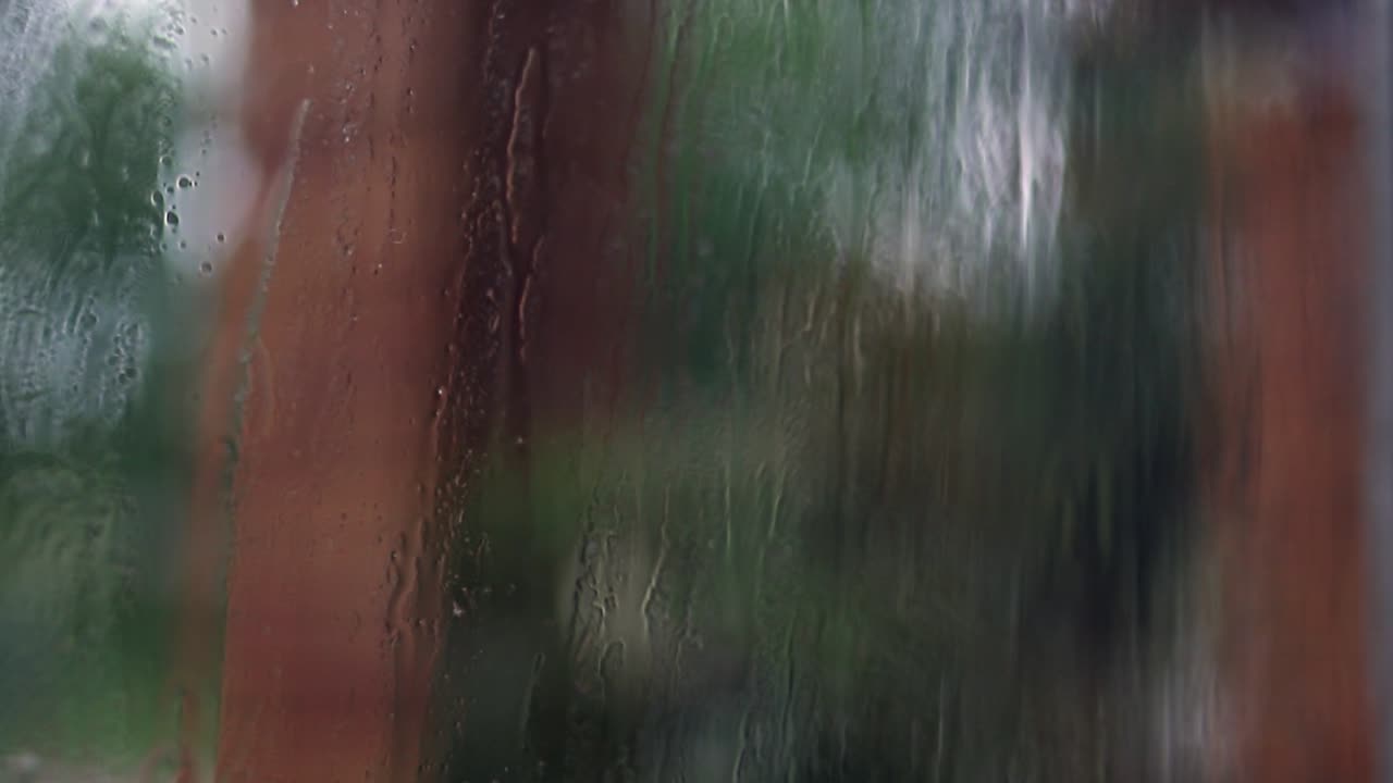 Atmospheric background: Rain drops on window pane from indoors, bokeh