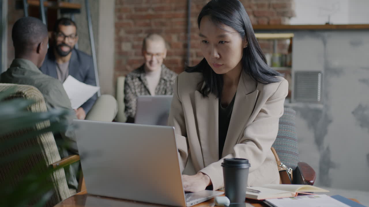 Businesswomen Working in a Cafe