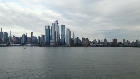 Aerial-drone-view-low-towards-the-Hudson-Yards-cityscape,-in-cloudy-New-York,-USA