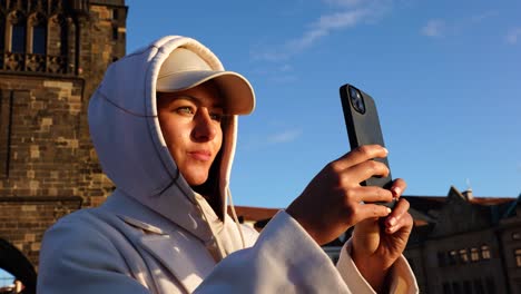 female tourist take photo of prague old town during blue sky and sunny day