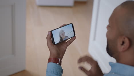 young-man-video-chatting-with-girlfriend-on-smartphone-waving-hand-greeting-young-woman-sharing-vacation-travel-couple-having-long-distance-relationship