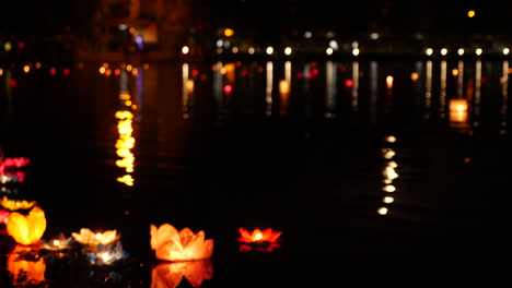 floating lanterns on a river at night