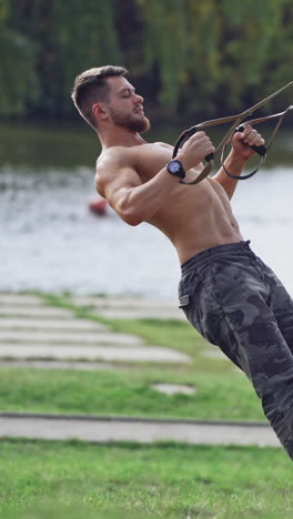 man doing exercise outdoors. fit young man exercising in park