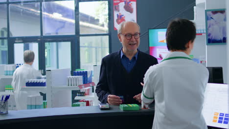 senior shopper at drugstore checkout