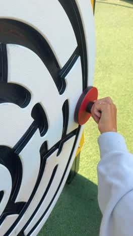 child's hand navigating an outdoor maze puzzle