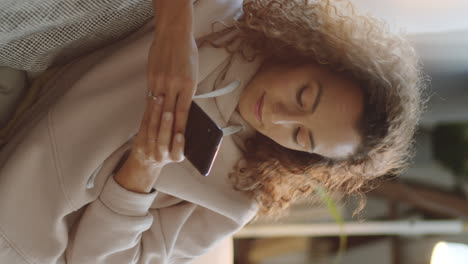 woman using smartphone at home