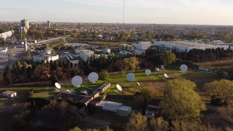 Parabolic-antennas-in-research-center-of-Buenos-Aires-and-skyline-at-sunset