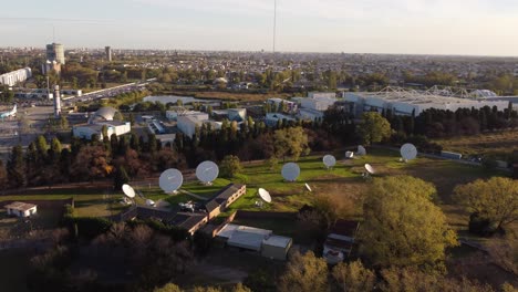 parabolic antennas in research center of buenos aires and skyline at sunset