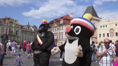 czech republic, street artists in inflatable bear and mole costumes on old town square, prague