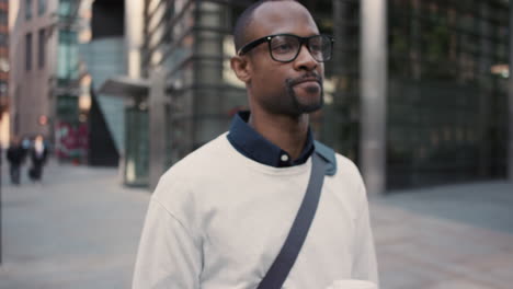 african american businessman walking through city