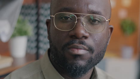 close-up portrait of a man wearing glasses