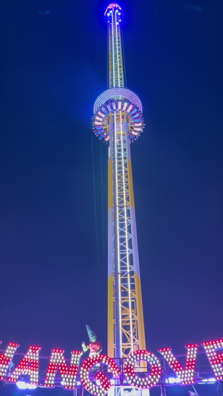The Hangover ride moving up at Winter Wonderland in the Hyde Park in London, England, in the evening. Vertical