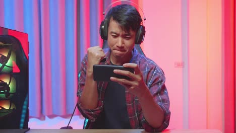 happy gamer celebrating victory on mobile game
