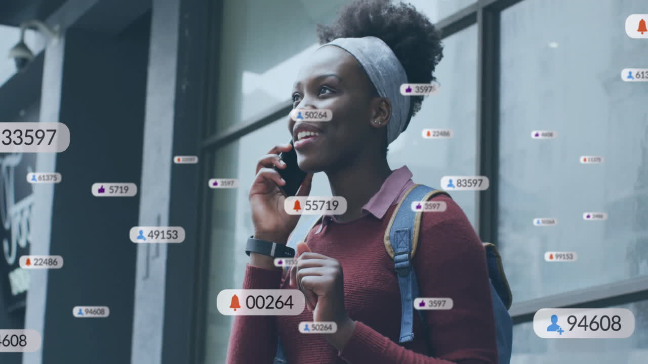 Animation of media icons over biracial woman using smartphone