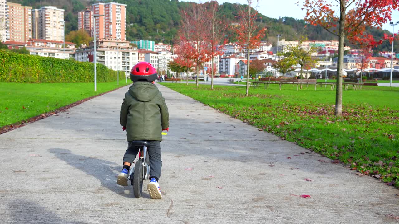 Boy riding a bike in a park