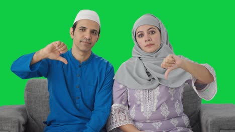 disappointed muslim couple showing thumbs down green screen