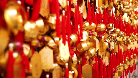 vibrant gold bells with red ribbons displayed