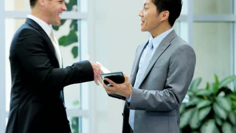 multi ethnic male female team meeting with tablet