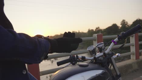 motorcycle rider at sunset on a bridge