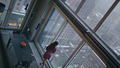 confident girl standing panoramic window high angle view. lady contemplating