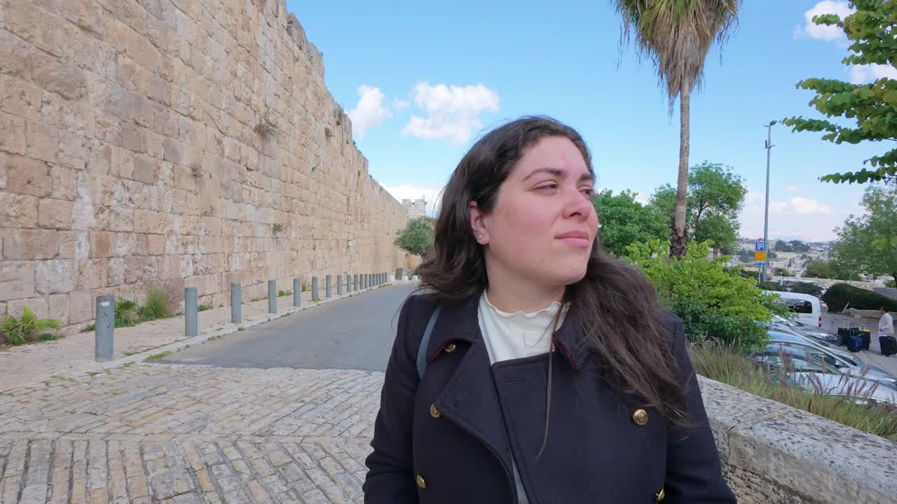 Woman walking near the old city wall