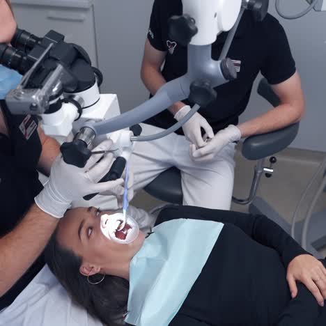 dentist working behind microscope