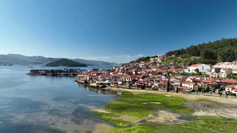 Orbiting-View-of-Combarro:-Harbor,-Village,-Beach,-and-Sea-on-a-sunny-day