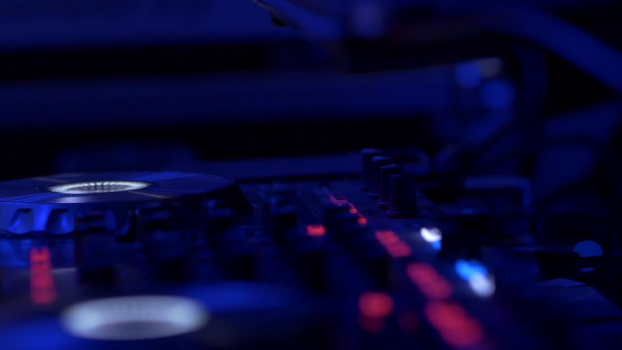 Close-up of DJ Mixer in a Dark Nightclub