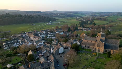 Aerial-footage-of-the-Medieval-village-of-Cartmel-in-the-English-Lake-District-it-has-a-rich-heritage,-and-varied-list-of-activities-for-visitors-and-tourists